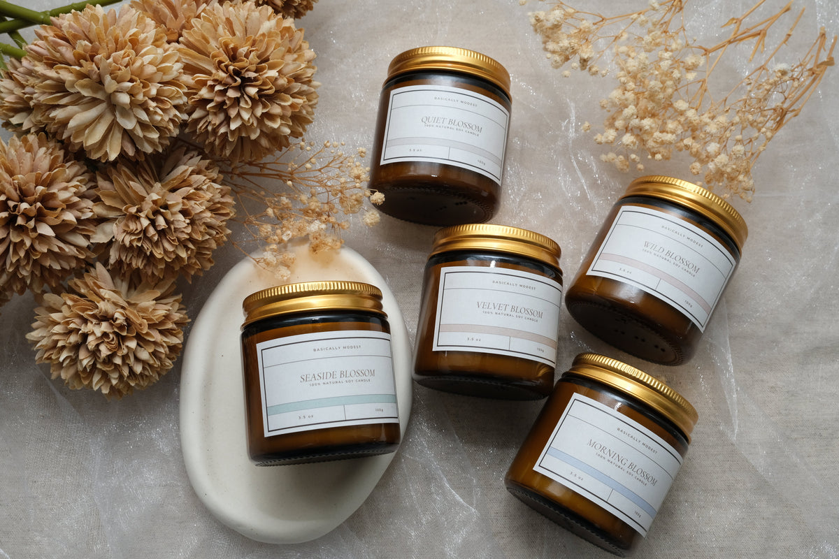 The Quiet Bloom candle collection featuring five handcrafted scented candles.